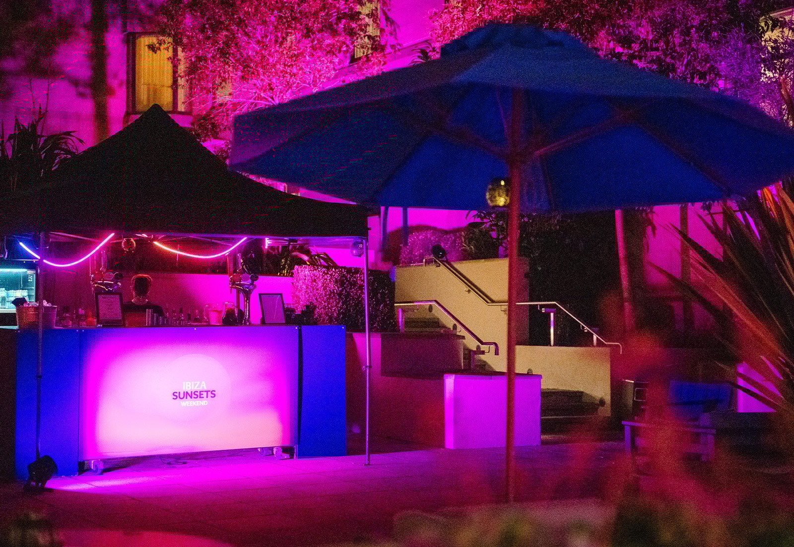 A touch of neon, a hint of evening magic - your perfect spot to unwind.