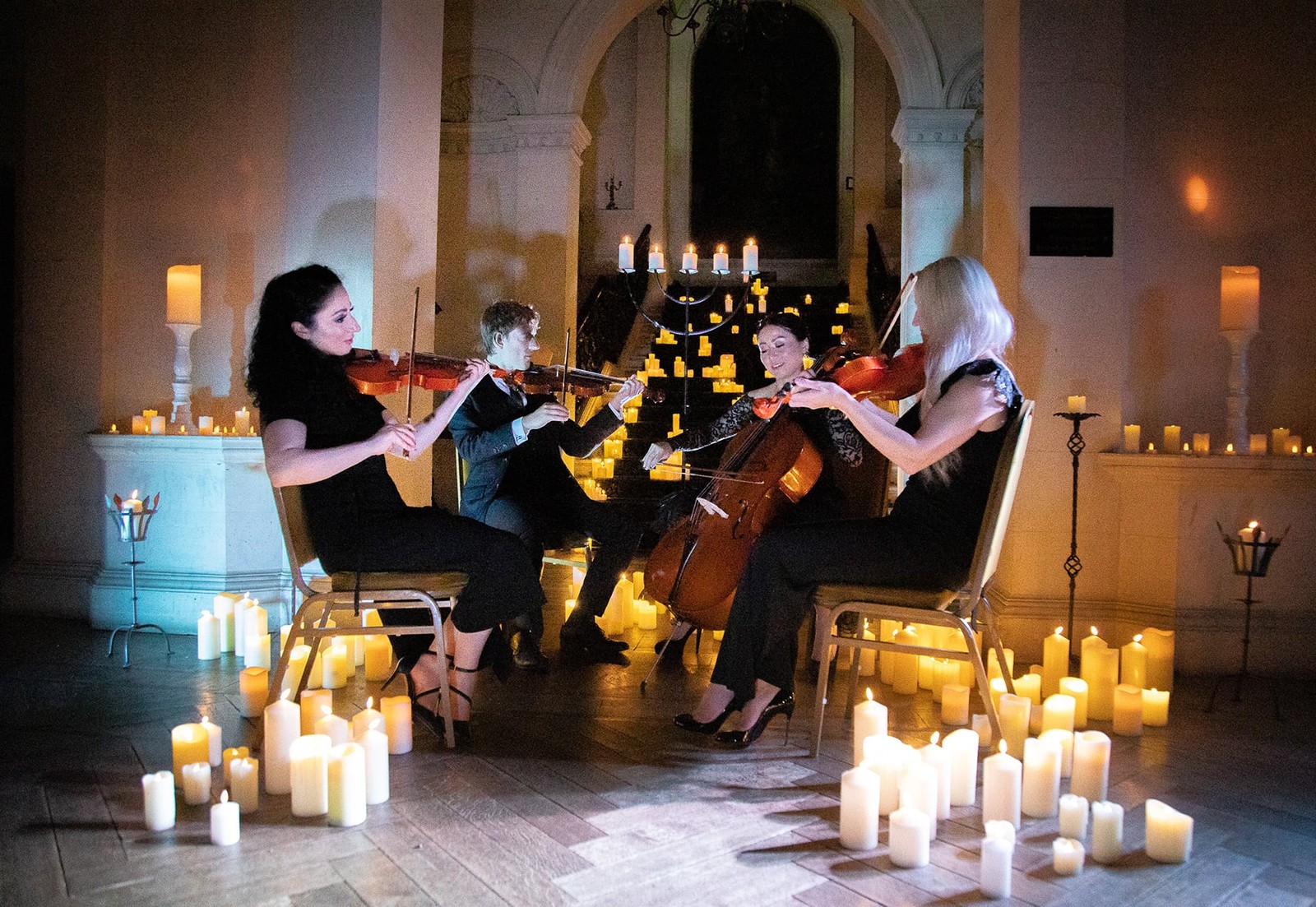 The glow of candlelight and the sound of festive melodies during a candlelit quartet performance create moments to remember (selected breaks).