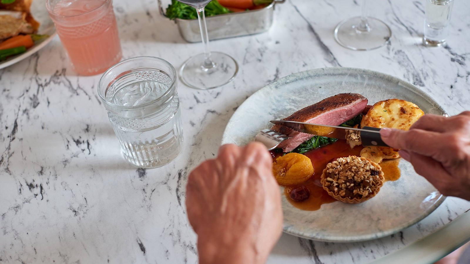 Main at Brasserie32: Duo of duck - Sliced duck breast, pulled duck ragu tartlet, spinach, dauphinoise potato, apricot puree, dark cherry sauce.