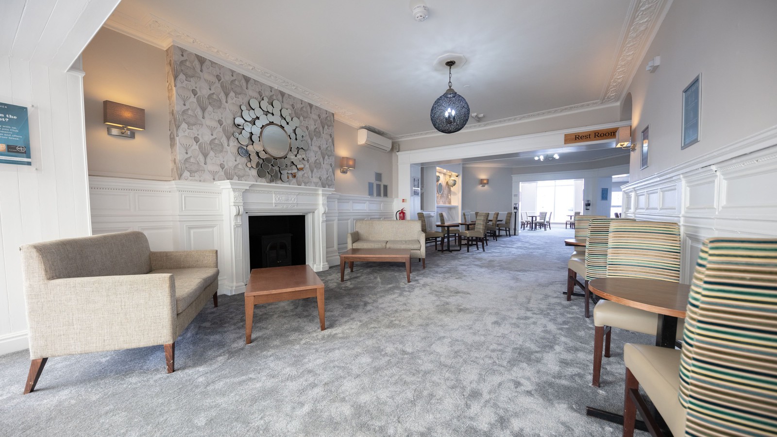 With a cosy fireplace and welcoming chairs, the lounge is perfect for relaxing or spending time with friends.