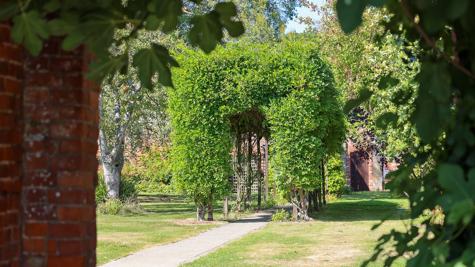 Stroll through the peaceful gardens at Gunton Hall and discover this charming topiary archway along the way.