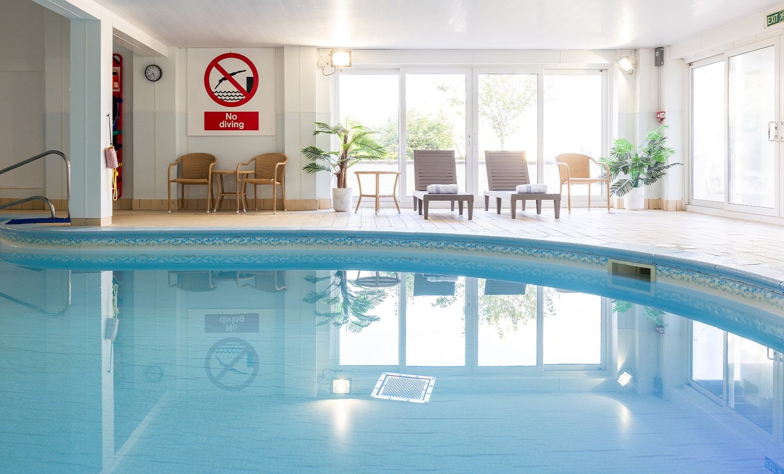 Relax in style at Corton with comfortable chairs and a serene indoor setting. Perfect for unwinding after a long day.