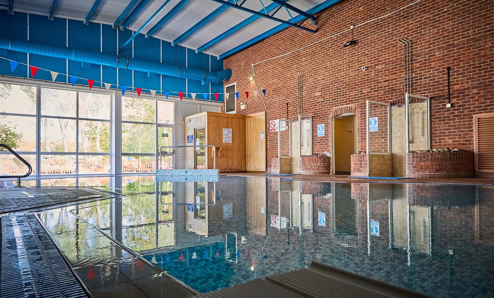 The charming brick walls and large windows surrounding Lakeside's indoor pool create a serene atmosphere, perfect for unwinding.