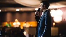 Speaker in suit giving a talk at BBC History Magazine Weekends at one of the Warner Hotels.