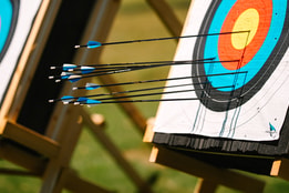 Close up view of two archery boards with arrows in