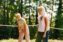 A couple of guests enjoying time together playing axe throwing