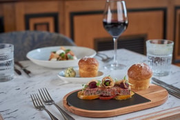 A beautifully set table at Brasserie32, featuring an array of delicious food and elegant wine, inviting a delightful dining experience.