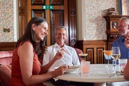 Guests at a table enjoying drinks