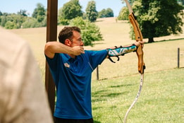Warner team member teaching archery