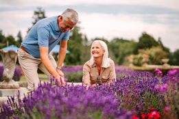 Couple admiring the flowers on the grounds of Cricket st. Thomas
