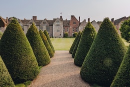 Littlecote House from between the topiary trees on the grounds