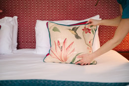 pillow being placed on bed