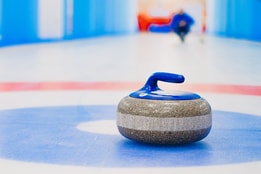 Close up of a curling stone on a target