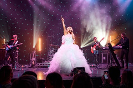 The Celine Experience performing in white dress