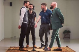 The four kicks in a white room with a mic