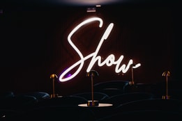 A neon sign saying Show