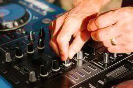 Close up of a DJs hands as he mixes music