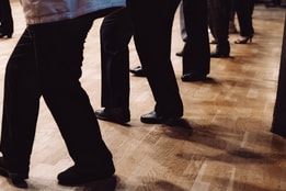 A group of people's legs as they dance in a line