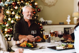 Guests toasting as they celebrate Christmas together at a Warner Hotel