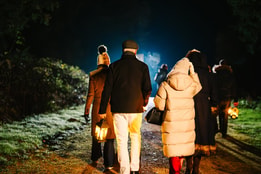 Guests wandering through the grounds on a lantern lit walk