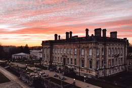 heythrop park hotel with a pink evening sky