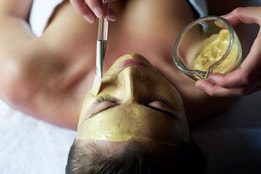 Person receiving a facial spa treatment
