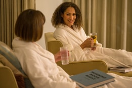 Two ladies relax in the relaxation room at Heythrop Park whilst they wait for their spa treatments