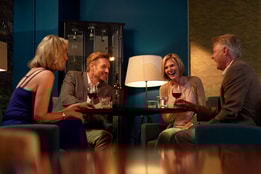 Friends gathered around a table with wine, sharing moments at the inviting Mulberry Lounge.