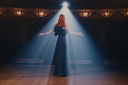 A lady singing in a theatre
