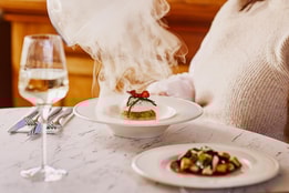 Close up of a steaming dish of smoked haddock fishcake