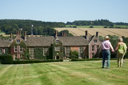 Two guests walking through the grounds of Littlecote House