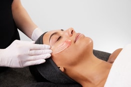 Women getting face massaged using medik8 products