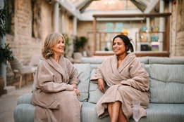 women in spa robes laughing