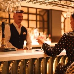 Guests enjoying drinks at a hotel bar.