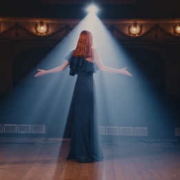 A lady singing in a theatre