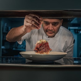 chef putting finishing touches to a dish