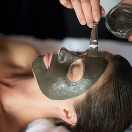 A guest enjoying a facial spa treatment during her spa break