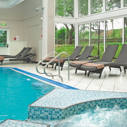 The spa at Bodelwyddan Castle, featuring a pool, bubble pool and loungers.