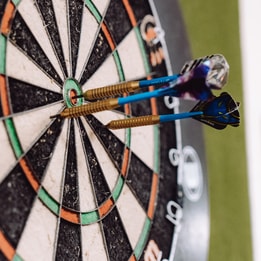 Darts board with darts in