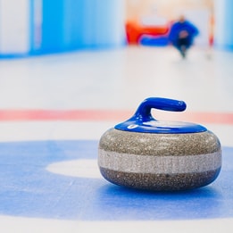 Close up of a curling stone on a target