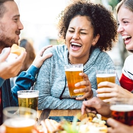 A group of friends eating and drinking at a food festival