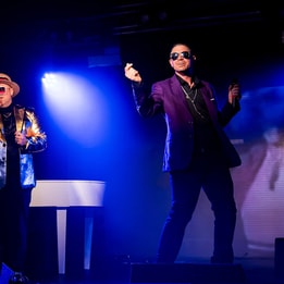 Russell Keith as George Michael, Adam Rose as Elton John