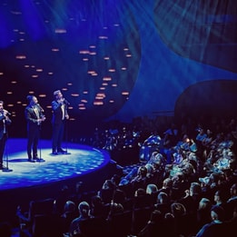 The West End Tenors performing on stage in front of a live audience