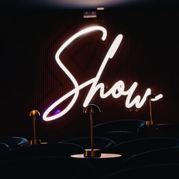 A neon sign saying Show