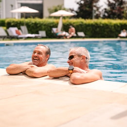 Guests relaxing in an outdoor swimming pool.