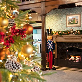 Christmas tree in front of a fireplace with nut crackers
