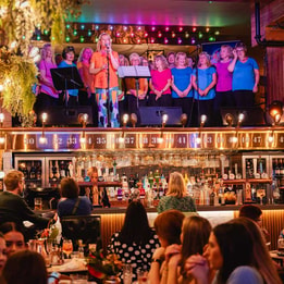 people singing on ceiling in a pub
