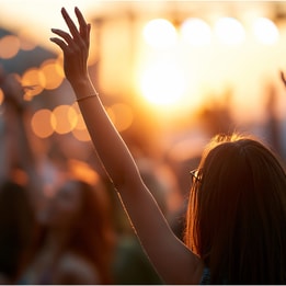 women outside with hands up