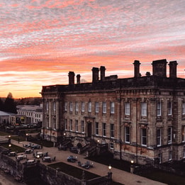 heythrop park hotel with a pink evening sky