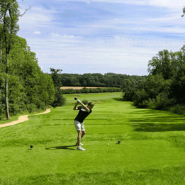 Golfer perfecting his swing on the green golf course at Heythrop Park.